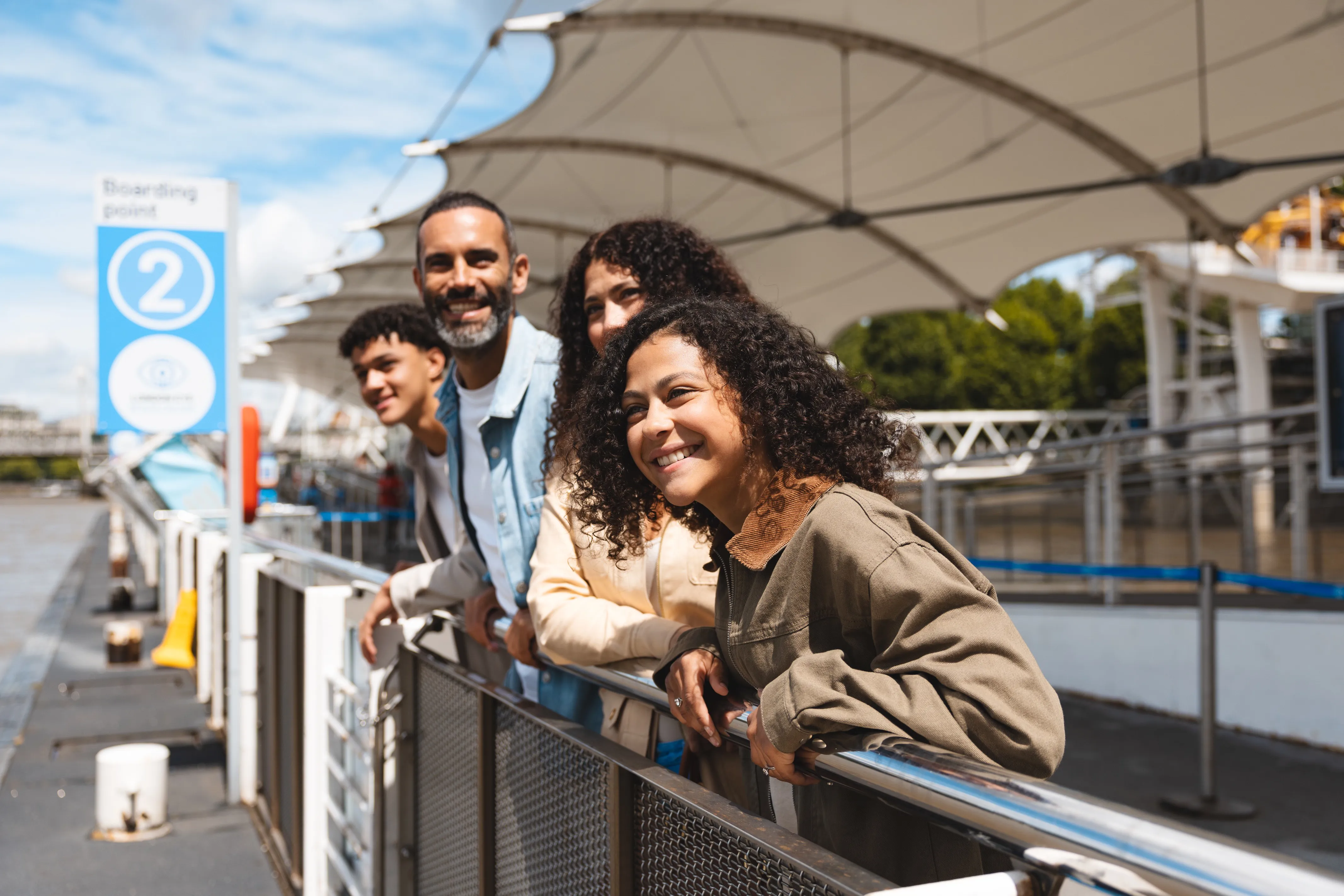 Family looking out over the Thames on the London Eye pier