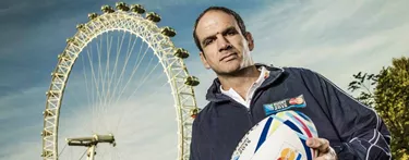 Martin Johnson holding rugby ball in front of London Eye