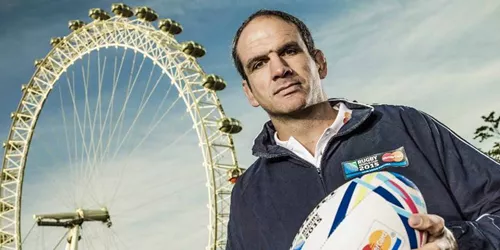 Martin Johnson holding rugby ball in front of London Eye
