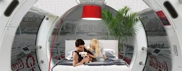 Apartment installed in London Eye with two people on bed