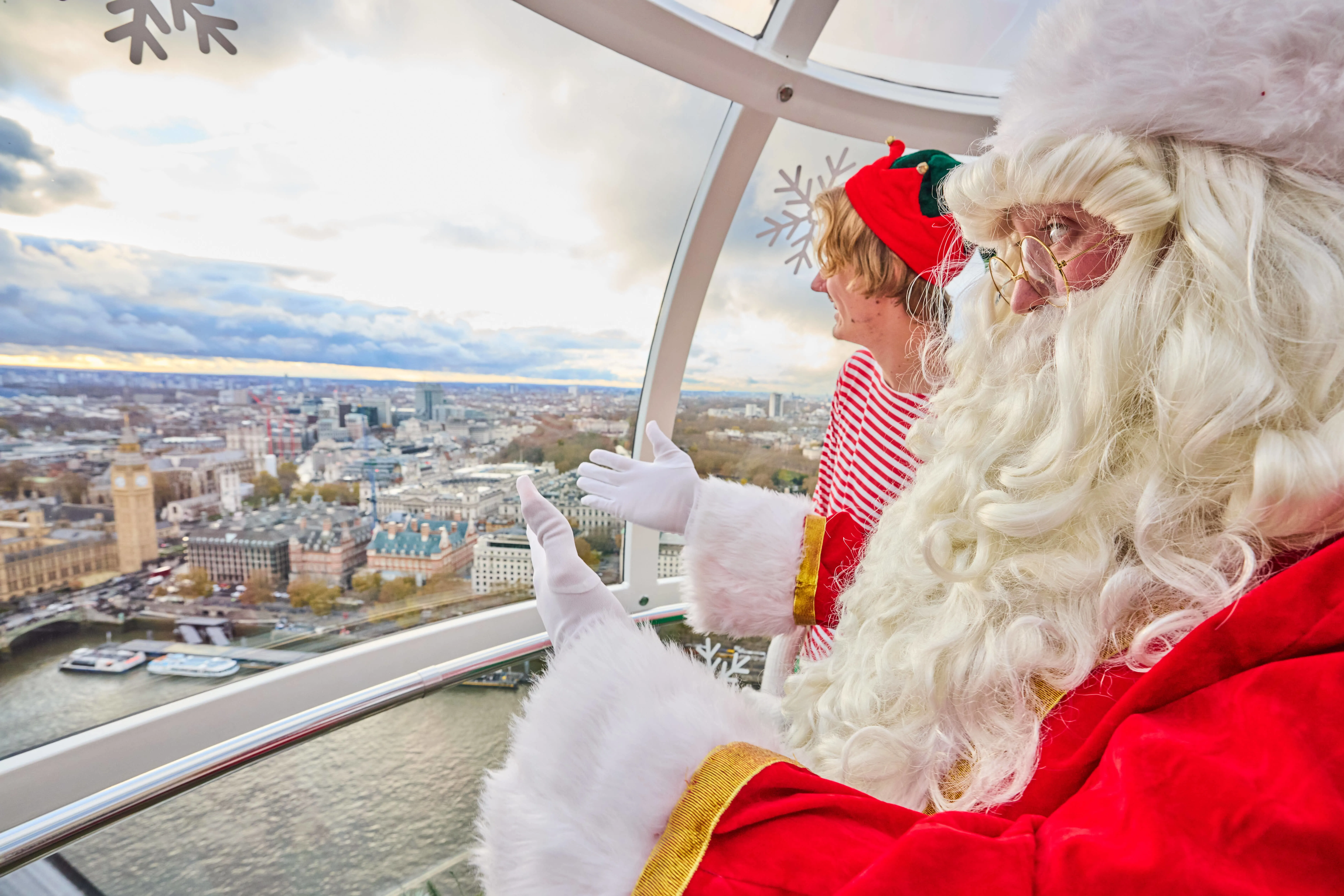 Santa and Elf in a London Eye capsule pod to celebrate the festive season on the London Eye