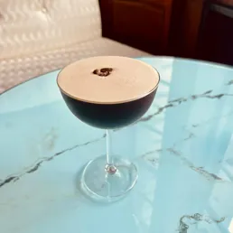Close up of an Espresso Martini garnished with coffee beans, served at the Eye Lounge Bar at the London Eye.