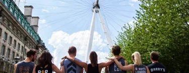 People standing in front of london eye in gym wear