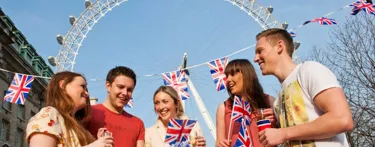 People celebrating queen's birthday in front of London Eye