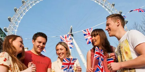 People celebrating queen's birthday in front of London Eye